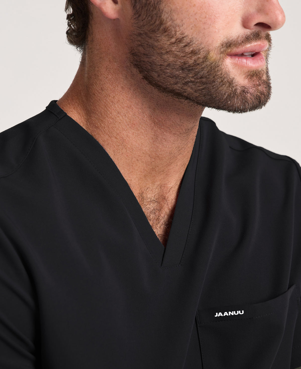Jaanuu Holmes 1-Pocket Scrub Top in Black, product photo 2 of 6
