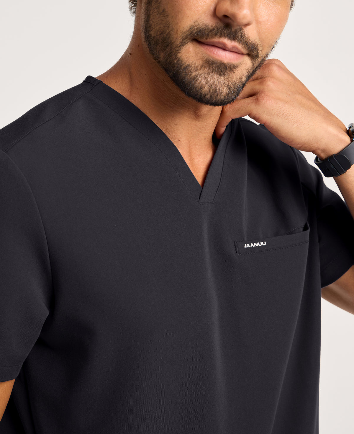 Jaanuu Platt 3-Pocket Scrub Top in Black, product photo 2 of 6