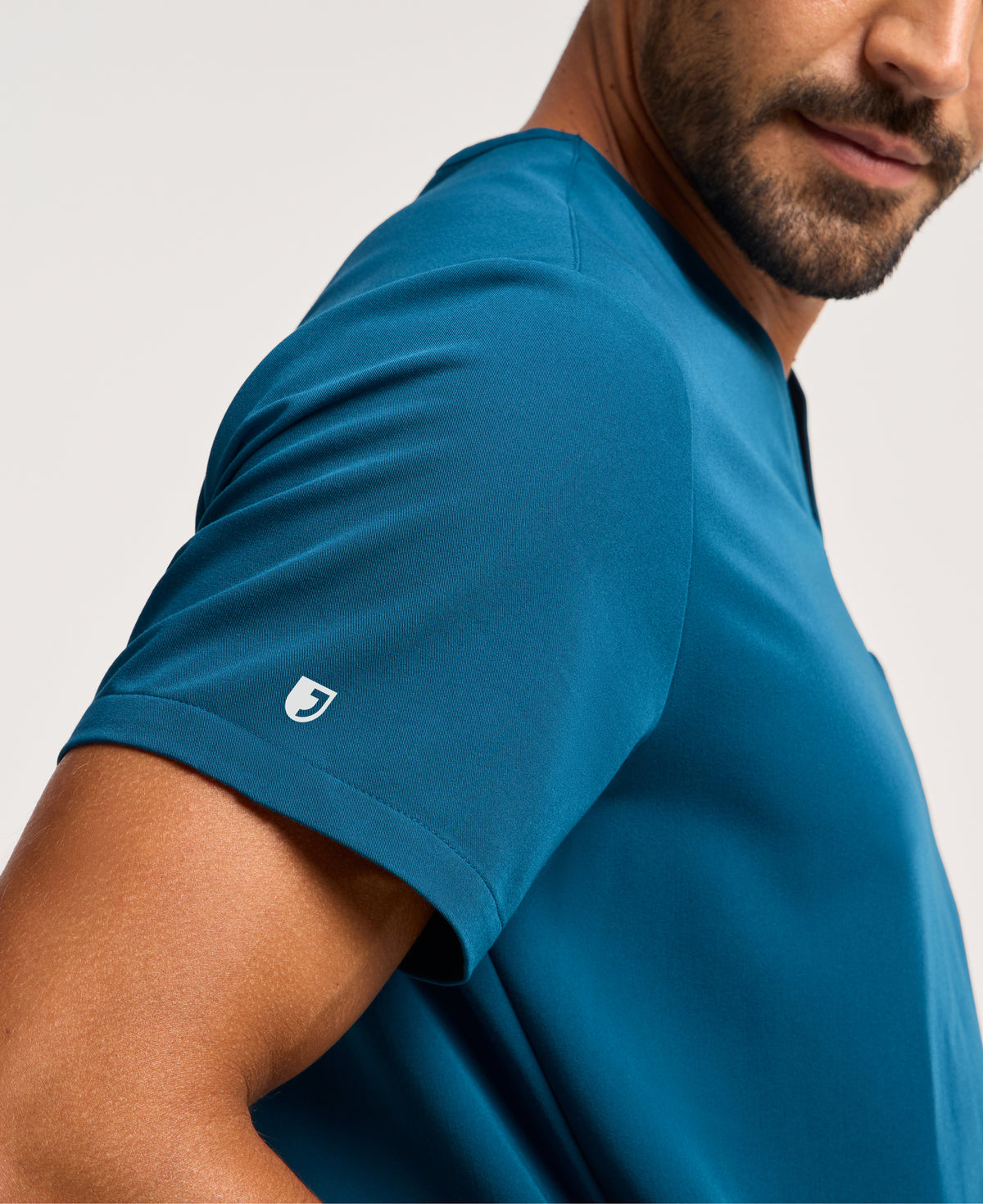 Jaanuu Platt 3-Pocket Scrub Top in Caribbean Blue, product photo 2 of 6