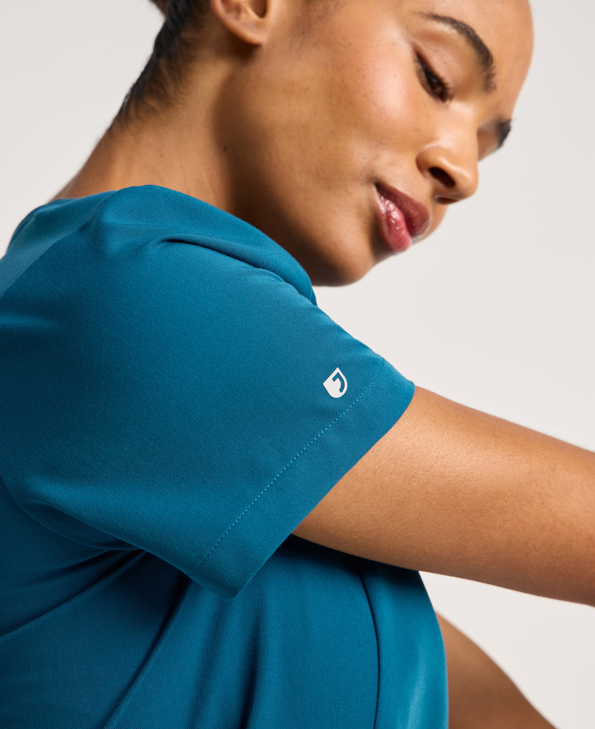 Jaanuu Calix Fit & Flare Scrub Top in Caribbean Blue, product photo 2 of 6