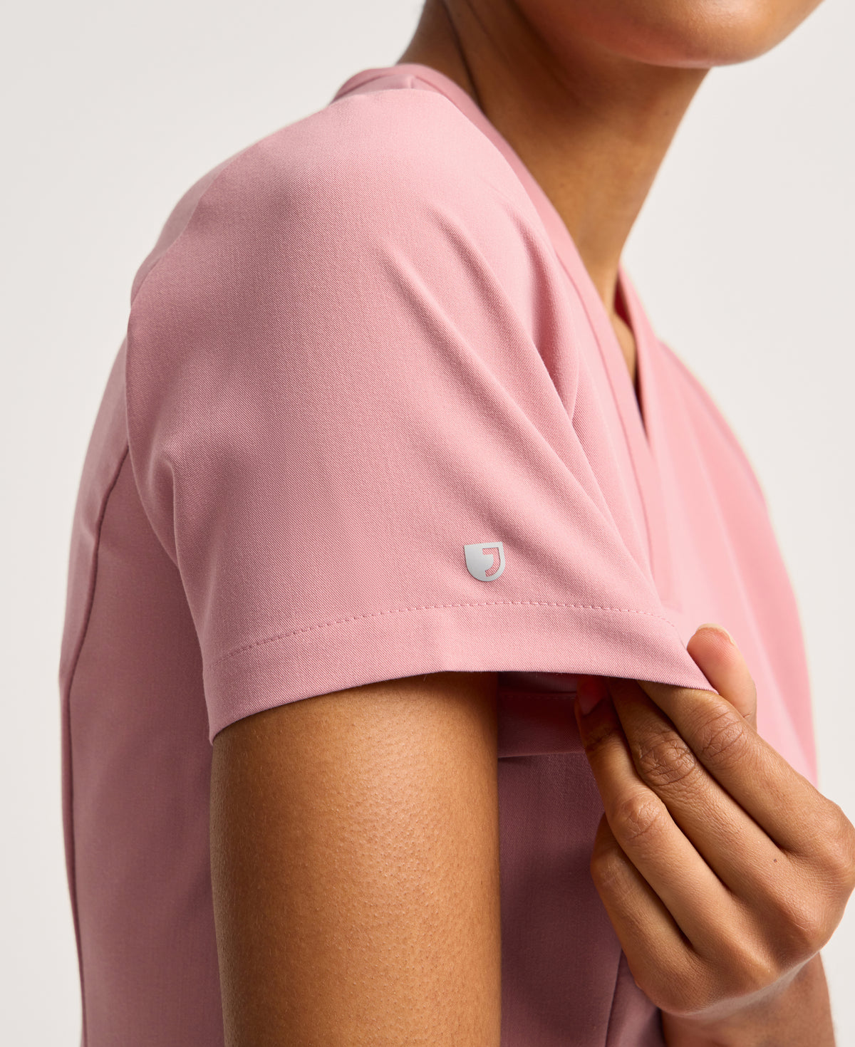 Jaanuu Calix Fit & Flare Scrub Top in Mauve, product photo 2 of 6
