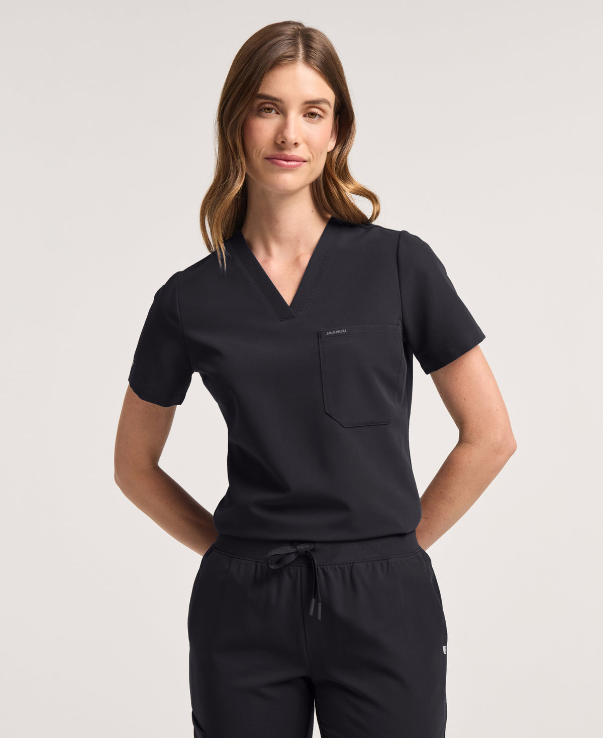 Jaanuu Rhena Slim 1-Pocket Scrub Top in Black, product photo 2 of 6