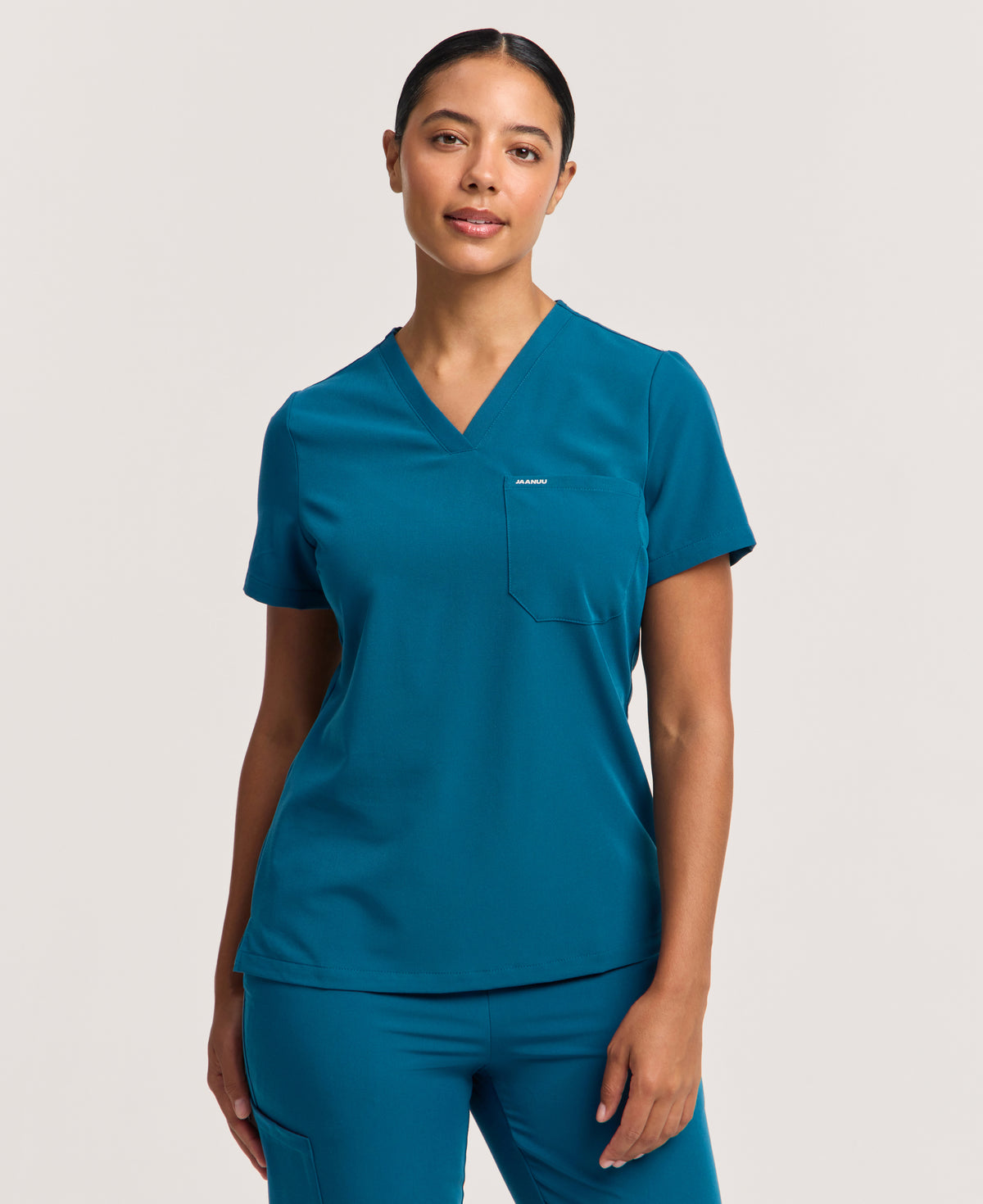 Jaanuu Rhena Slim 1-Pocket Scrub Top in Caribbean Blue, product photo 2 of 6