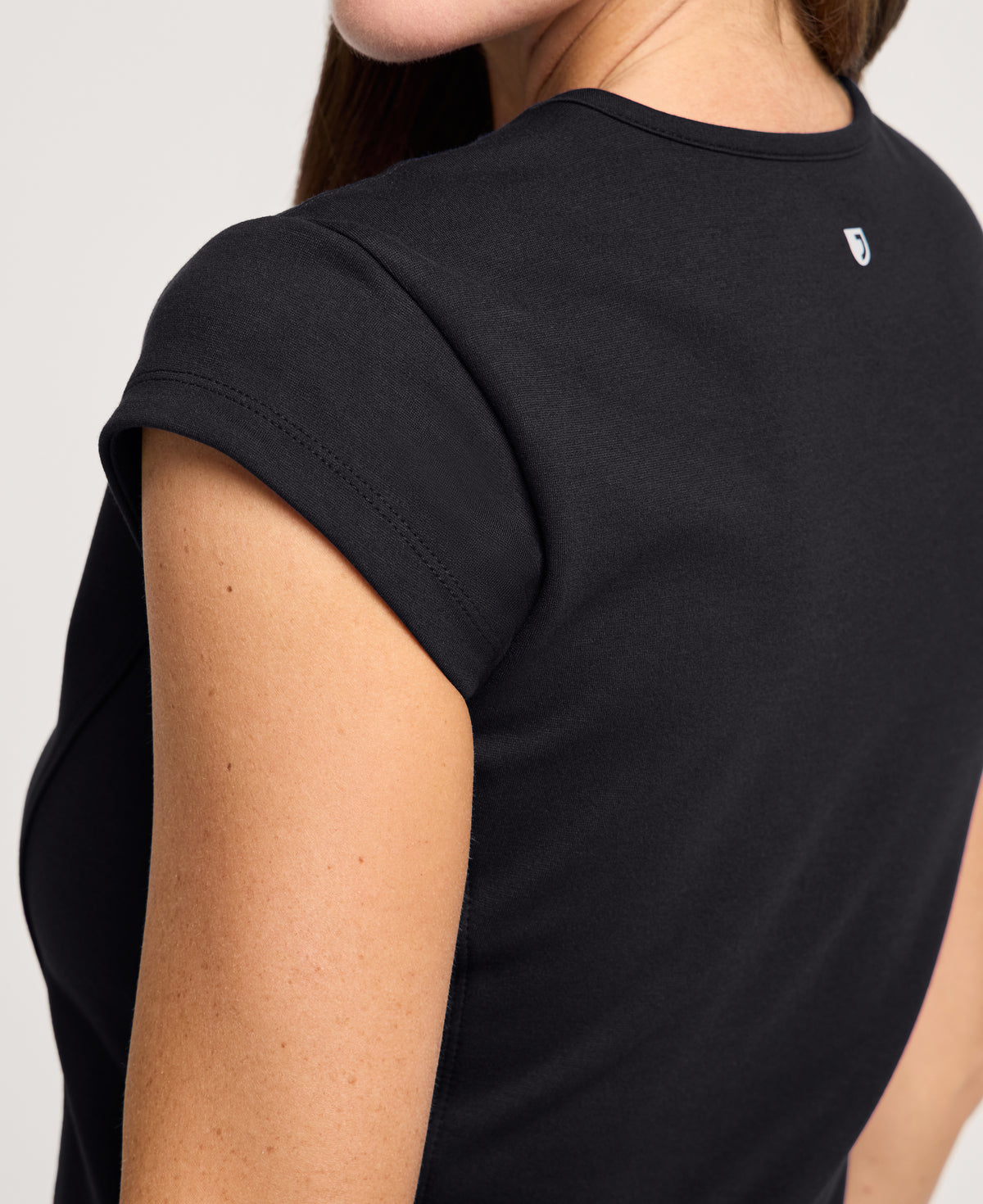 Jaanuu Isla Mock-Wrap Scrub Top in Black, product photo 2 of 6