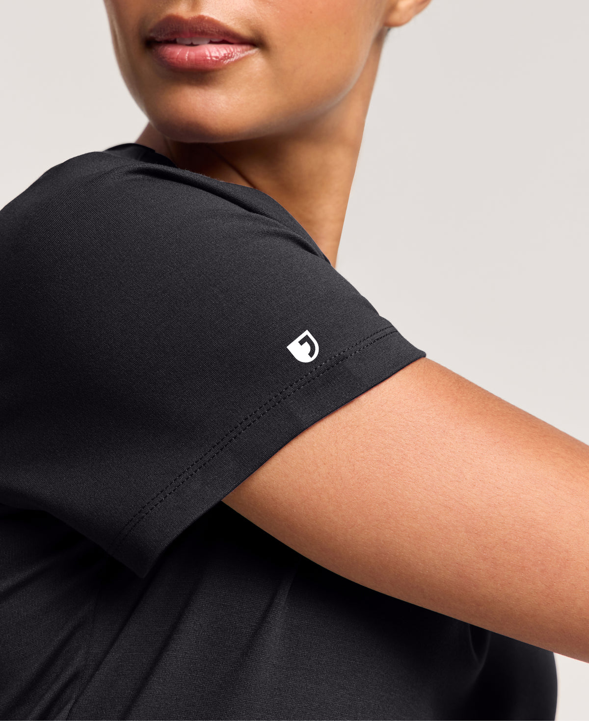 Jaanuu Cesi Slim Scrub Top in Black, product photo 2 of 6