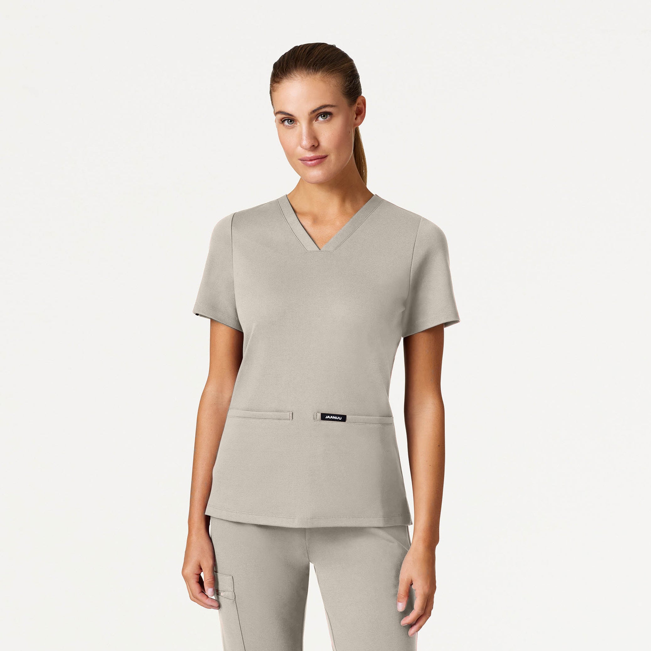 Woman wearing Fog color scrub set.