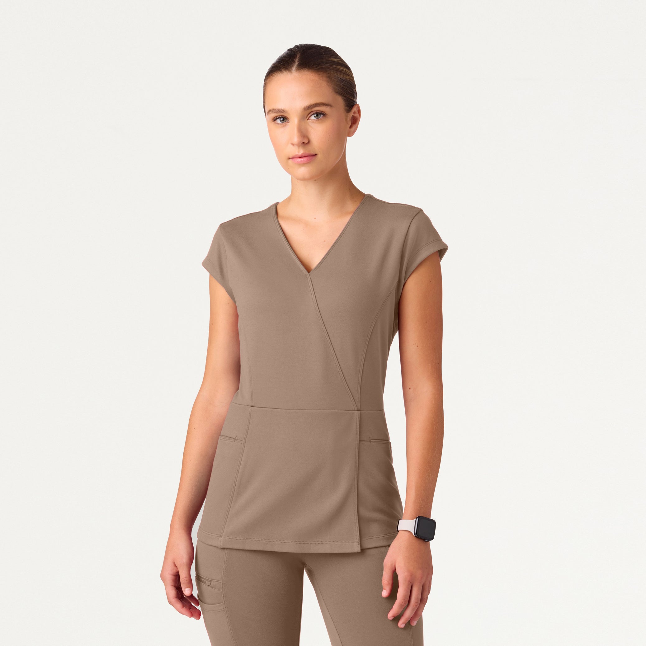 A woman wearing a Mocha scrub top