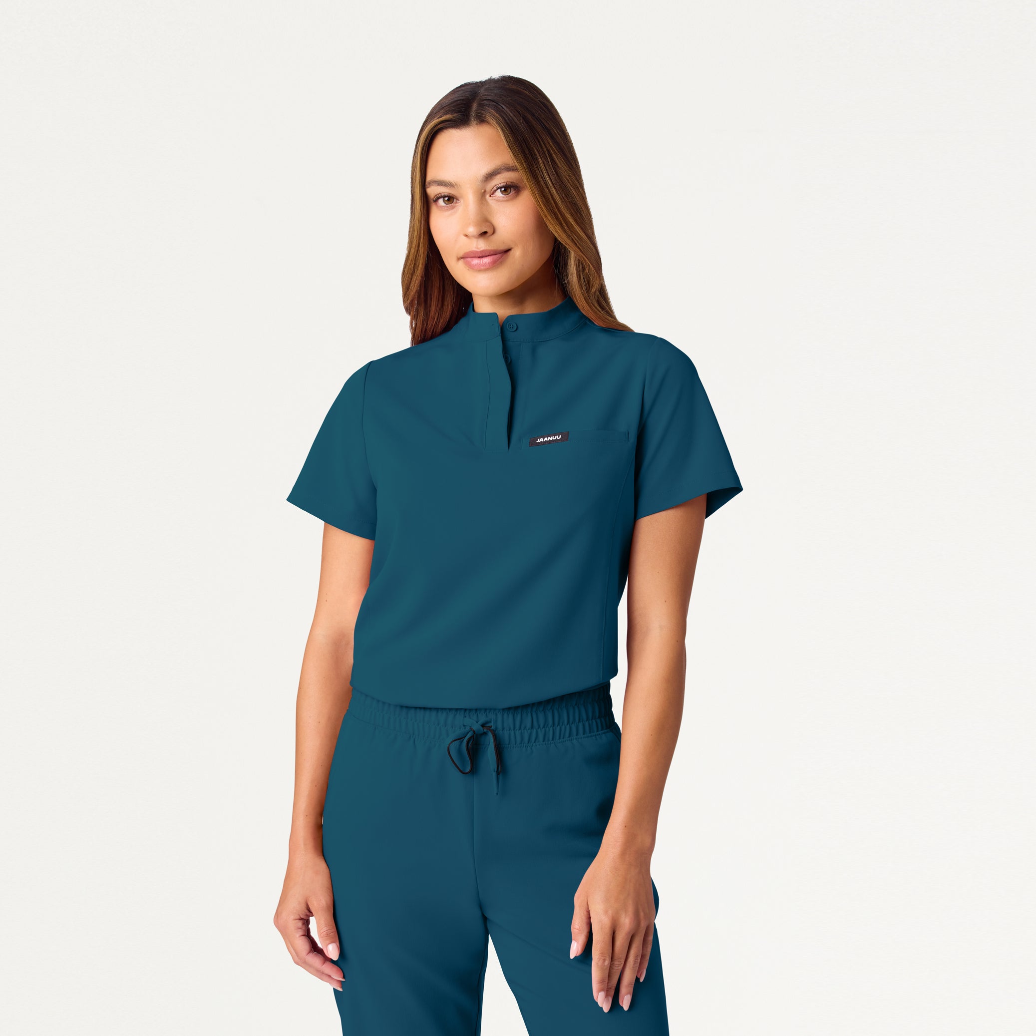 Woman wearing Caribbean Blue scrub top
