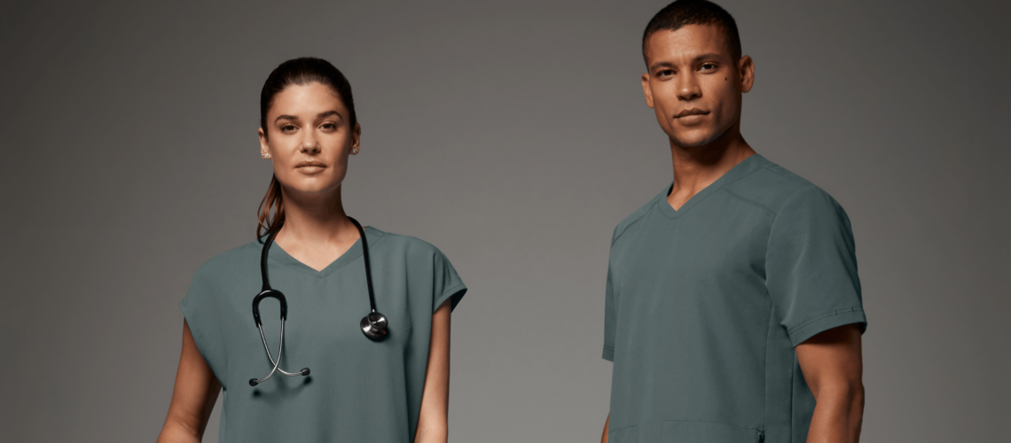 Man and woman with stethoscopes wearing scrubs