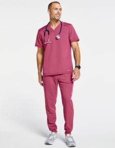 Man wearing paneled mesh v neck top scrubs in pink