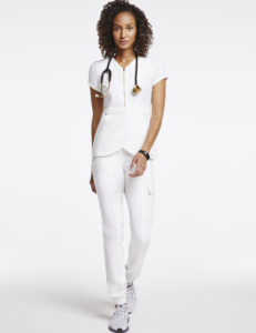 Woman wearing essential gold trim jogger scrubs in white