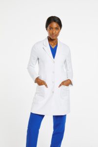 Woman wearing the signature lab coat in white