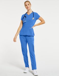 Woman wearing slim fit moto pant scrubs in blue
