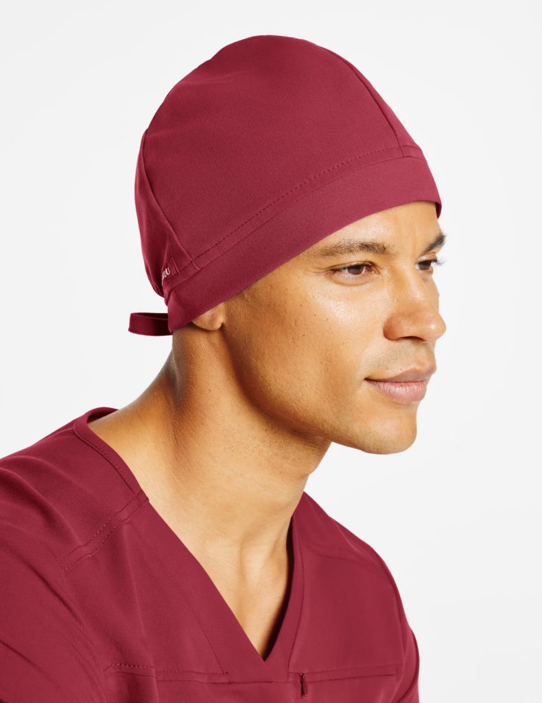 Man nurse wearing wine jaanuu scrub cap