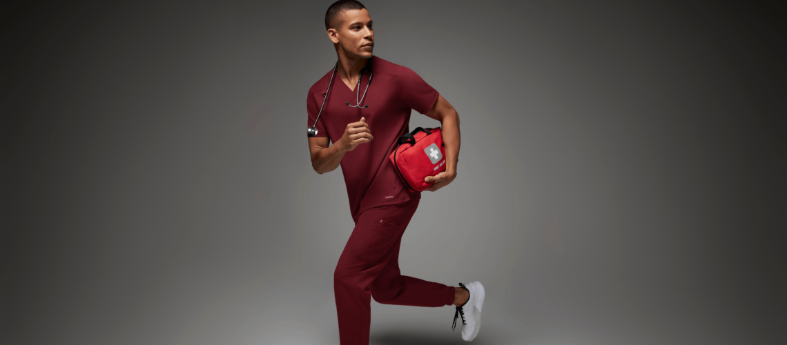 Man-with-red-scrubs-and-first-aid-kit