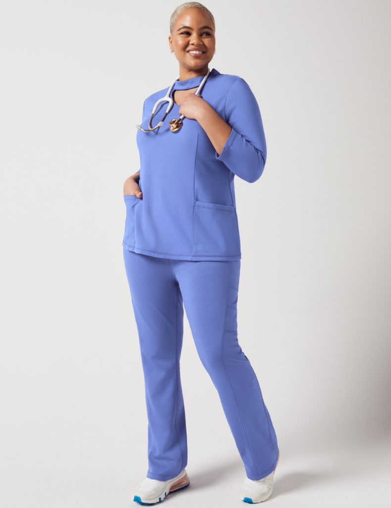 Nurse wearing mock neck top blue jaanuu scrubs