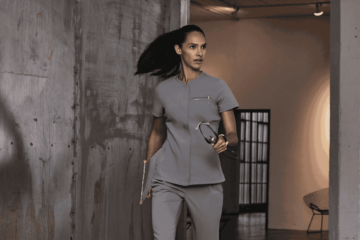 nurse wearing grey full zip top scrubs