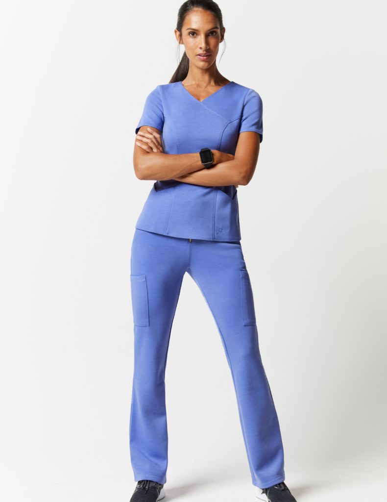 Nurse wearing blue zip front pant scrubs