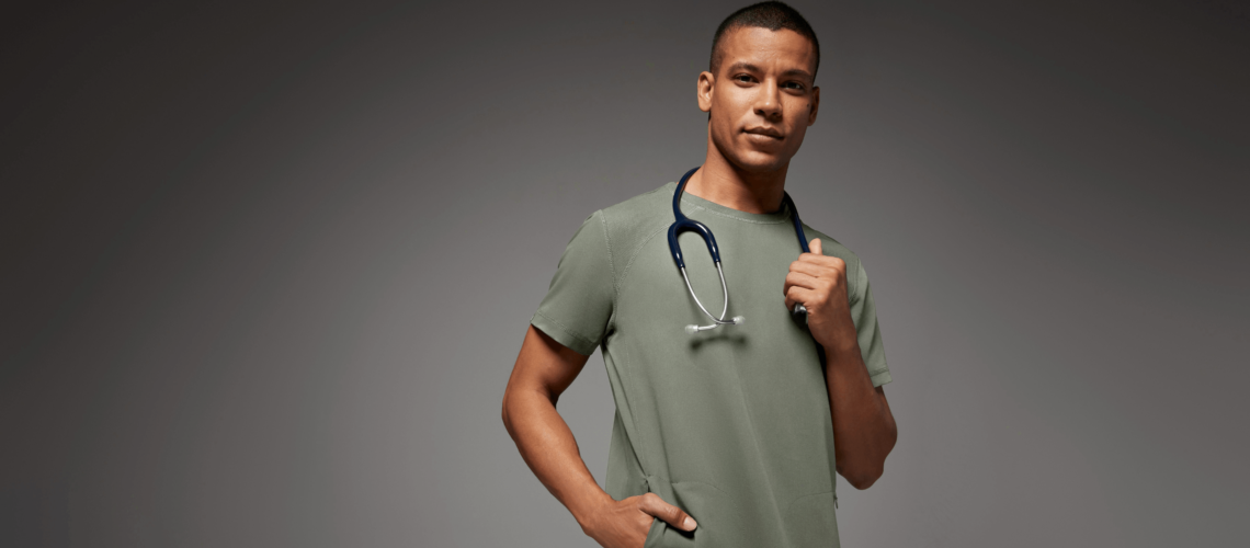 https://www.jaanuu.com/blog/wp-content/uploads/2022/06/Nurse-wearing-olive-jaanuu-scrubs-1140x500.png