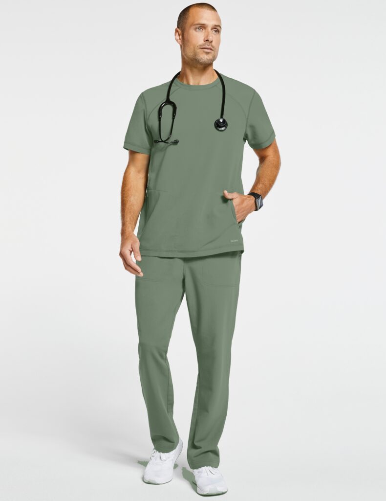 Health professional wearing green scrubs and tech device on wrist