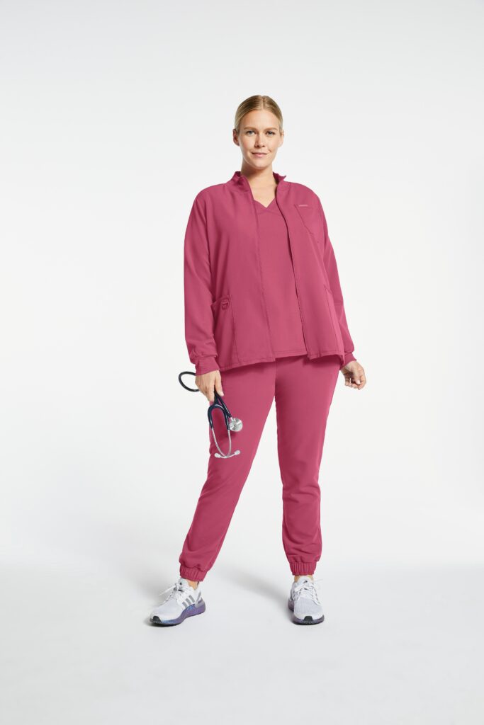 Blond woman doctor wearing pink scrub and scrub jacket