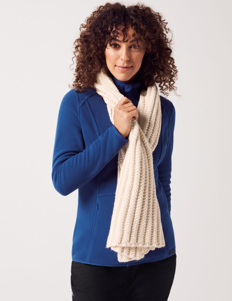 Female Medical Student wearing beige knitted scarf and blue scrub top