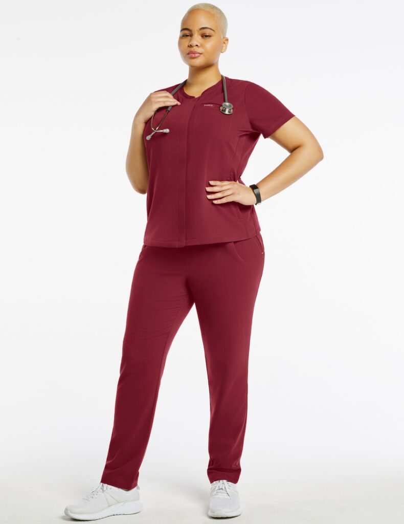 female plus size doctor wearing wine color scrubs and a stethoscope on her neck