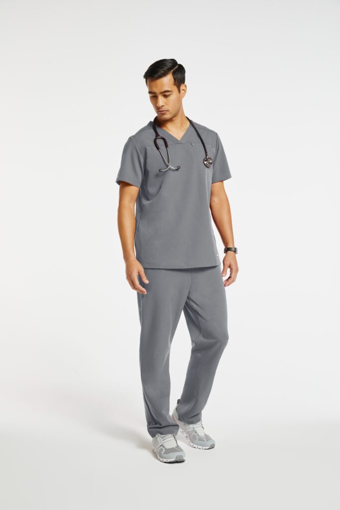 Male nurse wearing gray Jaanuu scrub top and pants