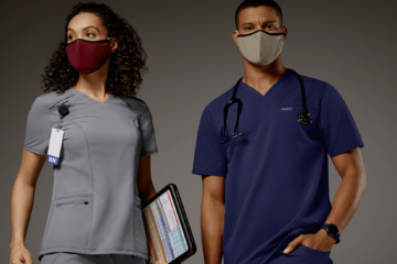 Female and male oncology nurses wearing short sleeve scrubs and reusable masks