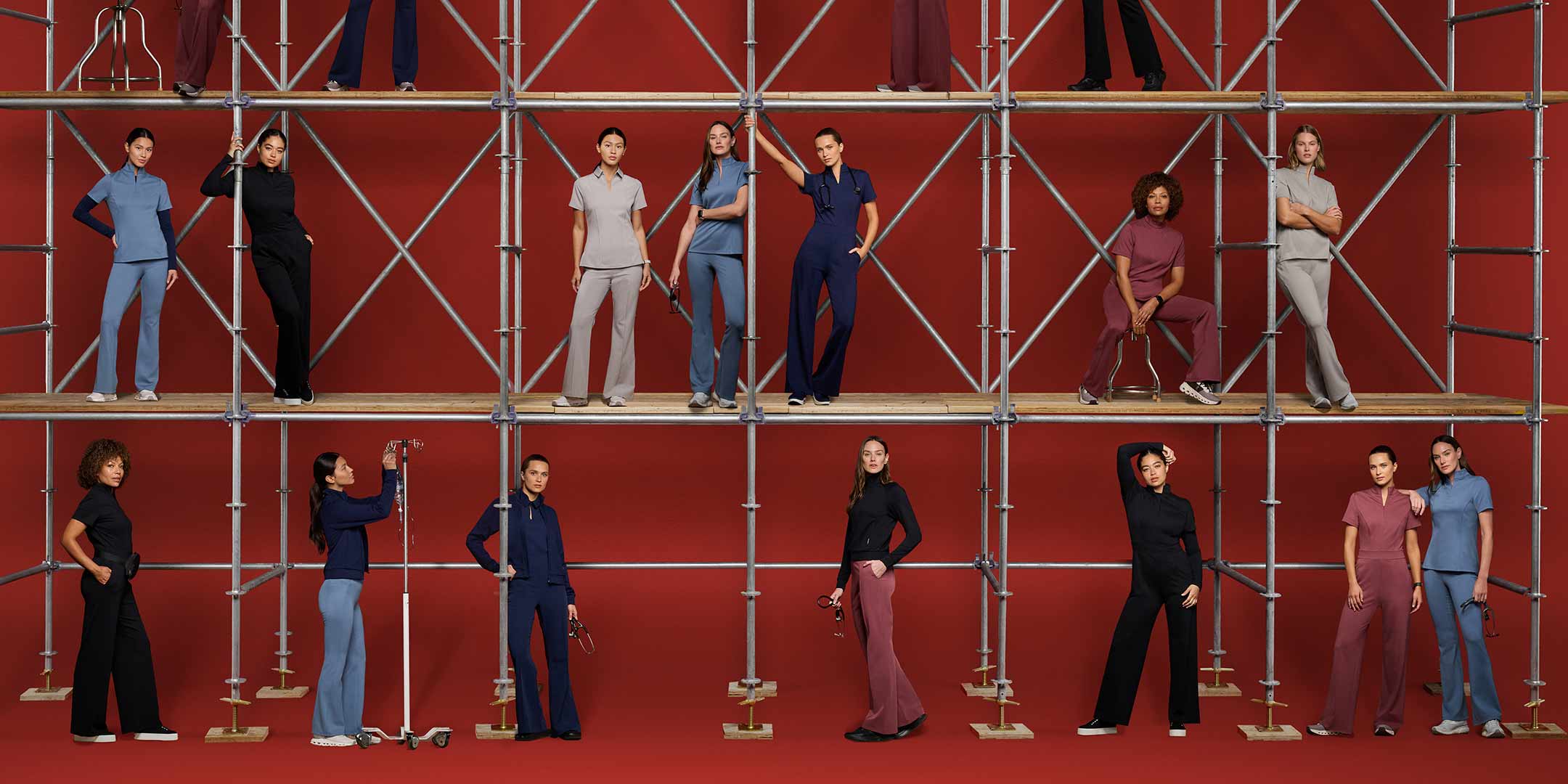 Women wearing scrubs standing at floor level and on platforms.