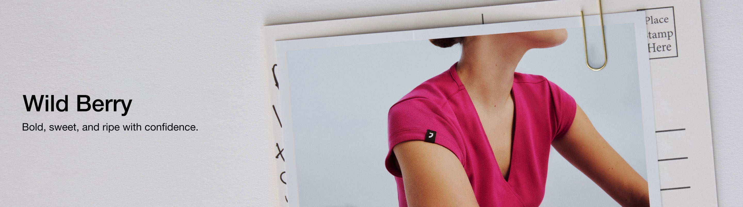 Image of a woman wearing JAANUU Wild Berry scrubs. Image has text, "Wild Berry: Bold, sweet, and ripe with confidence."