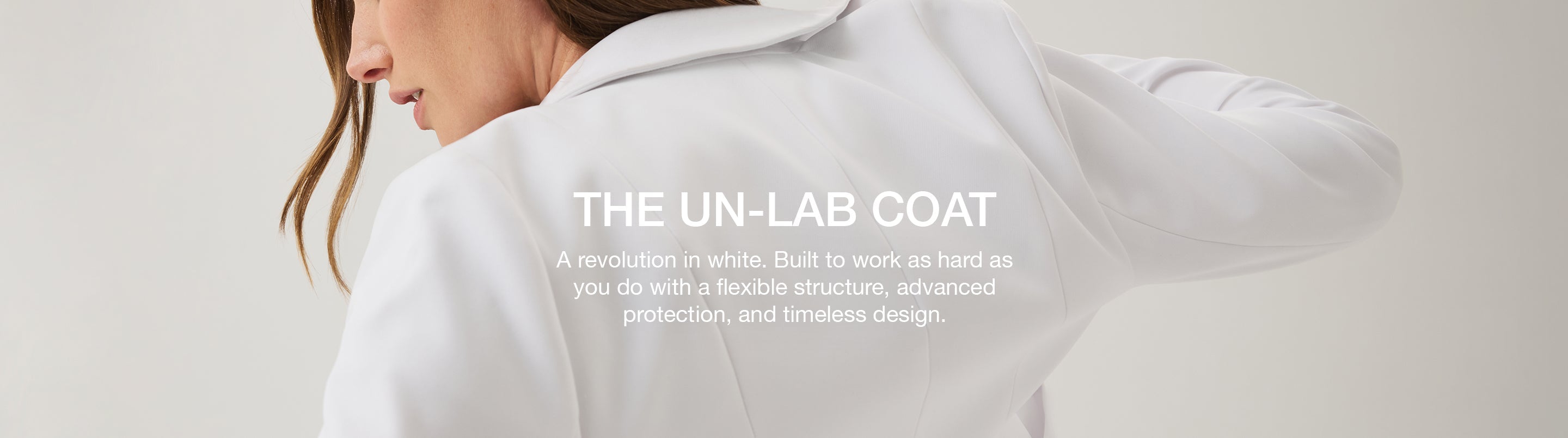 A women wearing white scrubs with her back turned and a text overlay that says "A revolution in white. Built to work as hard as you do with a flexible structure, advanced protection, and timeliness design."