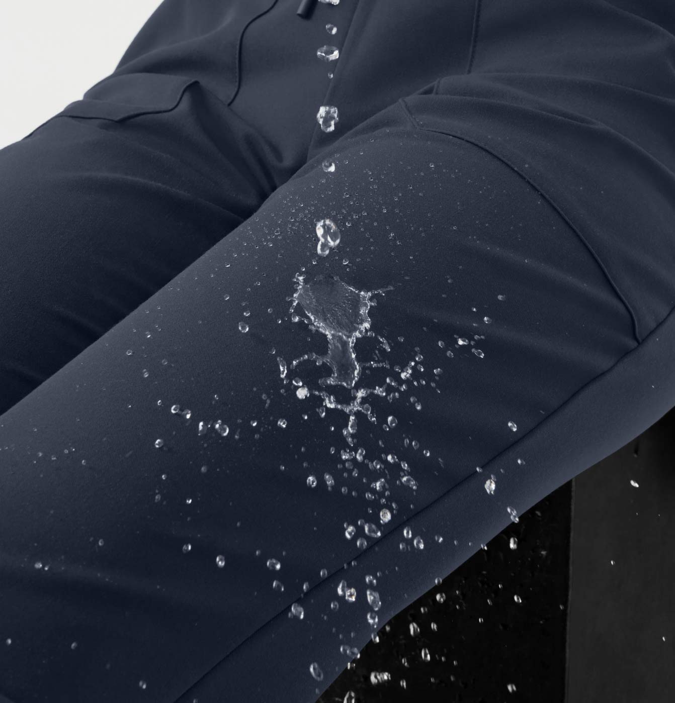 Water being poured on water-repellant finished scrubs.