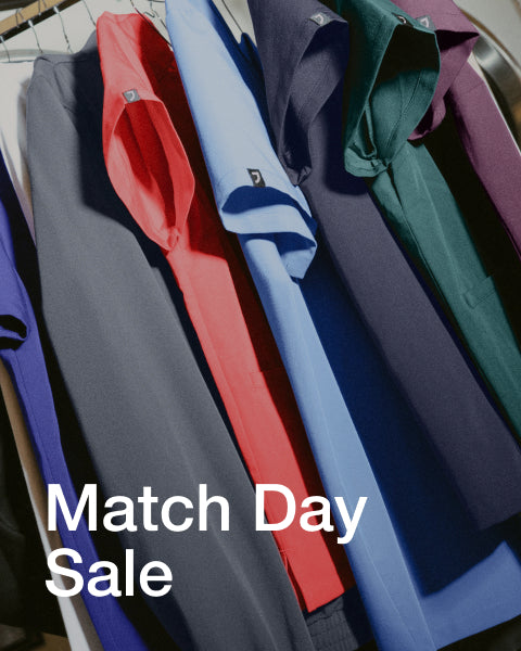 An assortment of Jaanuu scrubs in different colors. - Women Nav Tile