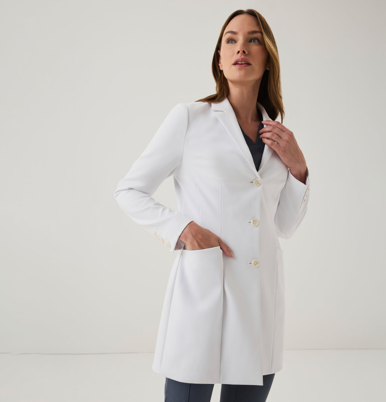 Woman wearing white Jaanuu lab coat.