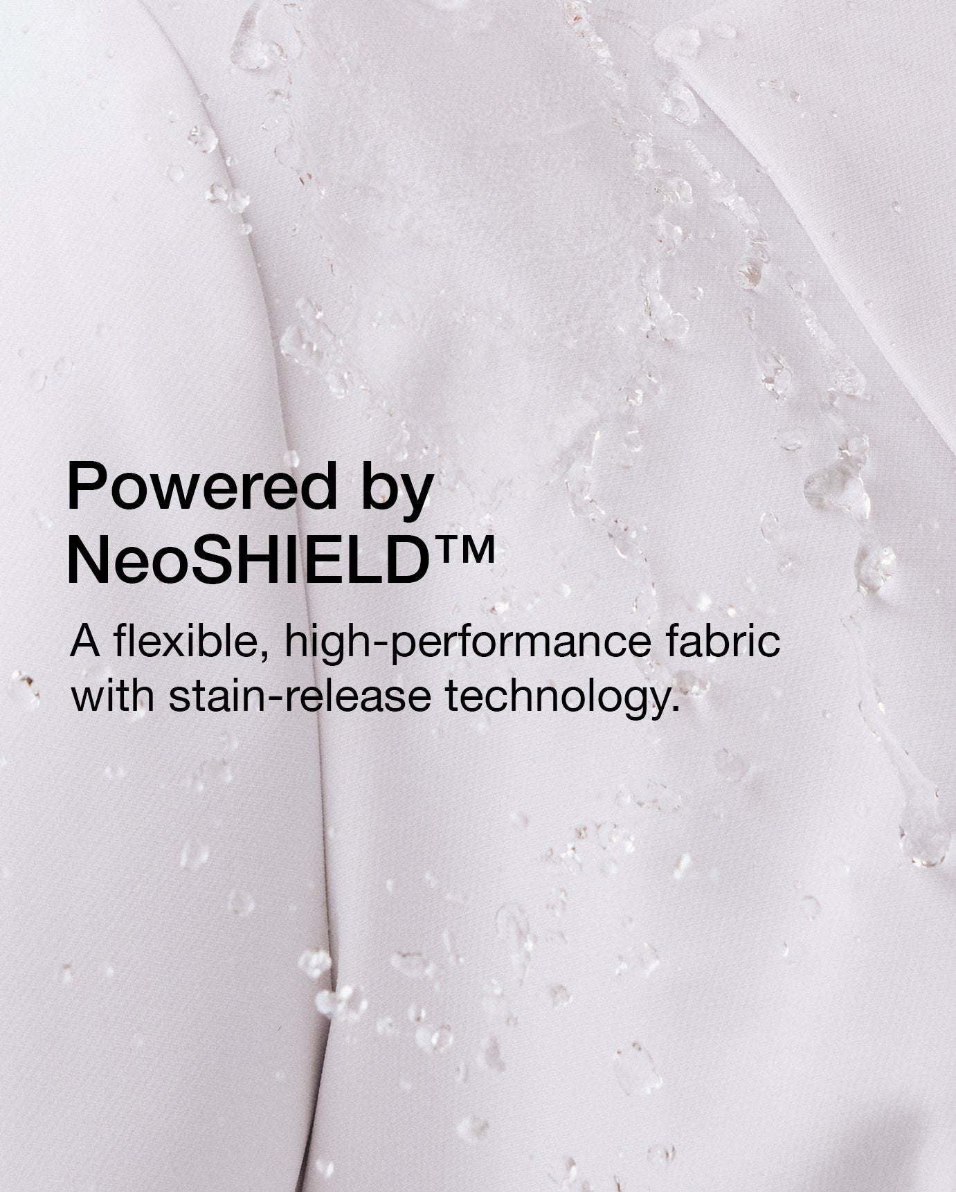 Close-up of white lab coat fabric with water droplets, with text 'Powered by NeoSHIELD™' and 'A flexible, high-performance fabric with stain-release technology.'