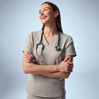 Woman wearing Fog color scrubs. - Women Nav Tile
