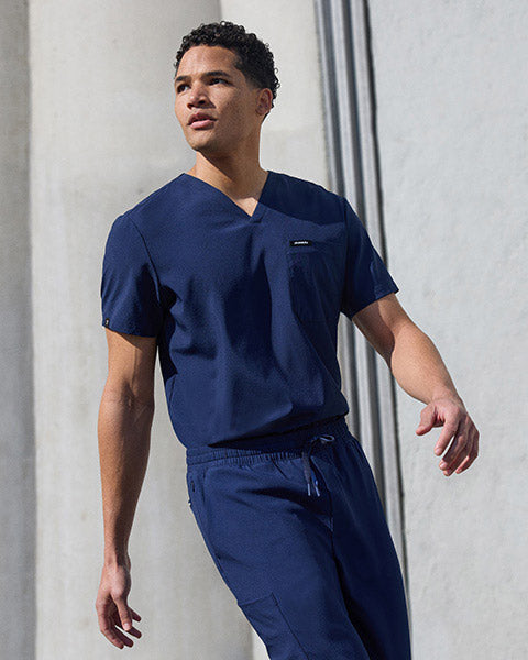 Man wearinig ULTRAlite scrubs walking. - Men Nav Tile