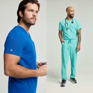 A man in a royal blue Jaanuu scrub top beside a man in a mint green Jaanuu scrub set with a stethoscope, on a light studio background. - Men Nav Tile