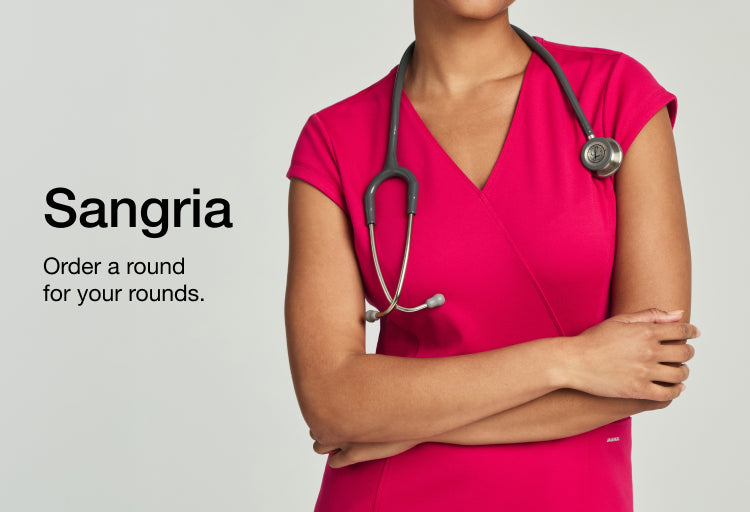 Promotional banner with the text 'Sangria' and 'Order a round for your rounds.' Beside it, a model in a hot-pink Sangria wrap scrub top with a stethoscope around her neck and arms crossed.