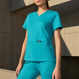 Woman wearing Teal color scrubs. - Women Nav Tile
