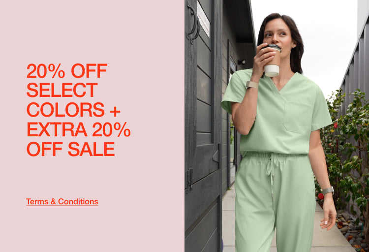 A woman in a sage green Jaanuu scrub set walking outdoors and sipping coffee, with text '20% Off Select Colors + Extra 20% Off Sale' and a 'Terms & Conditions' link.