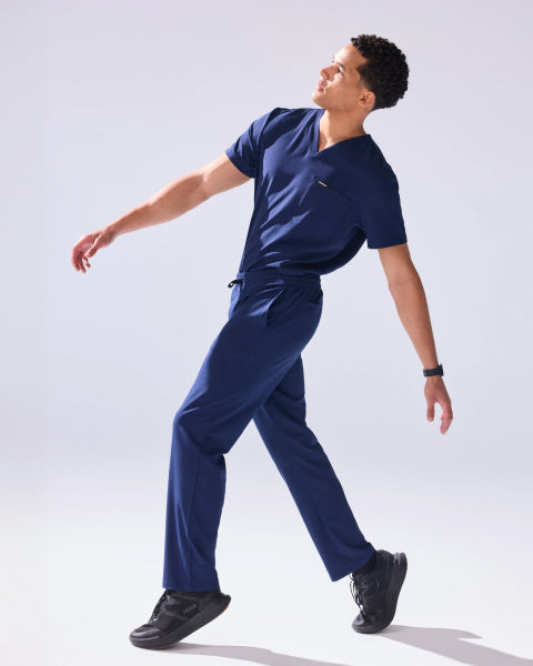 Jaanuu UltraLITE scrubs: a man wearing the navy UltraLITE V-neck top and pant. - Men Nav Tile