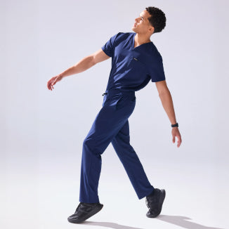 Jaanuu UltraLITE scrubs: a man wearing the navy UltraLITE V-neck top and pant. - Men Nav Tile