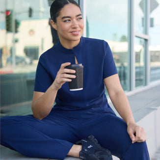 Jaanuu UltraLITE scrubs: a woman wearing the navy UltraLITE mock-neck top and pant. - Women Nav Tile