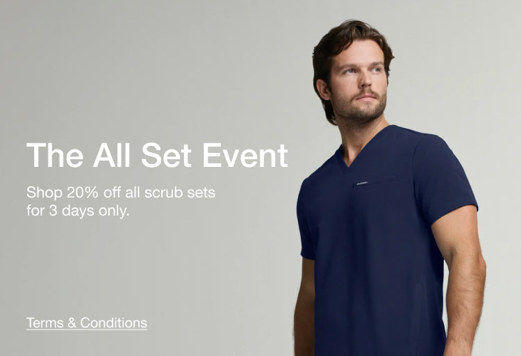 The All Set Event – Shop 20% off all scrub sets for 3 days only. A man wearing Jaanuu scrubs in midnight navy.