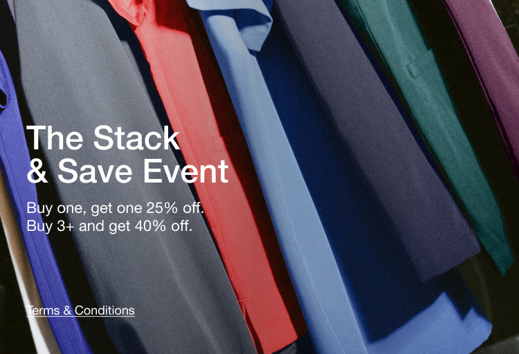 The Stack & Save Event – Buy one, get one 25% off. Buy 3+ and get 40% off. Close-up of colorful Jaanuu scrub tops hanging in a row.