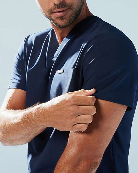 Man wearing UltraLITE™ scrub top. - Men Nav Tile