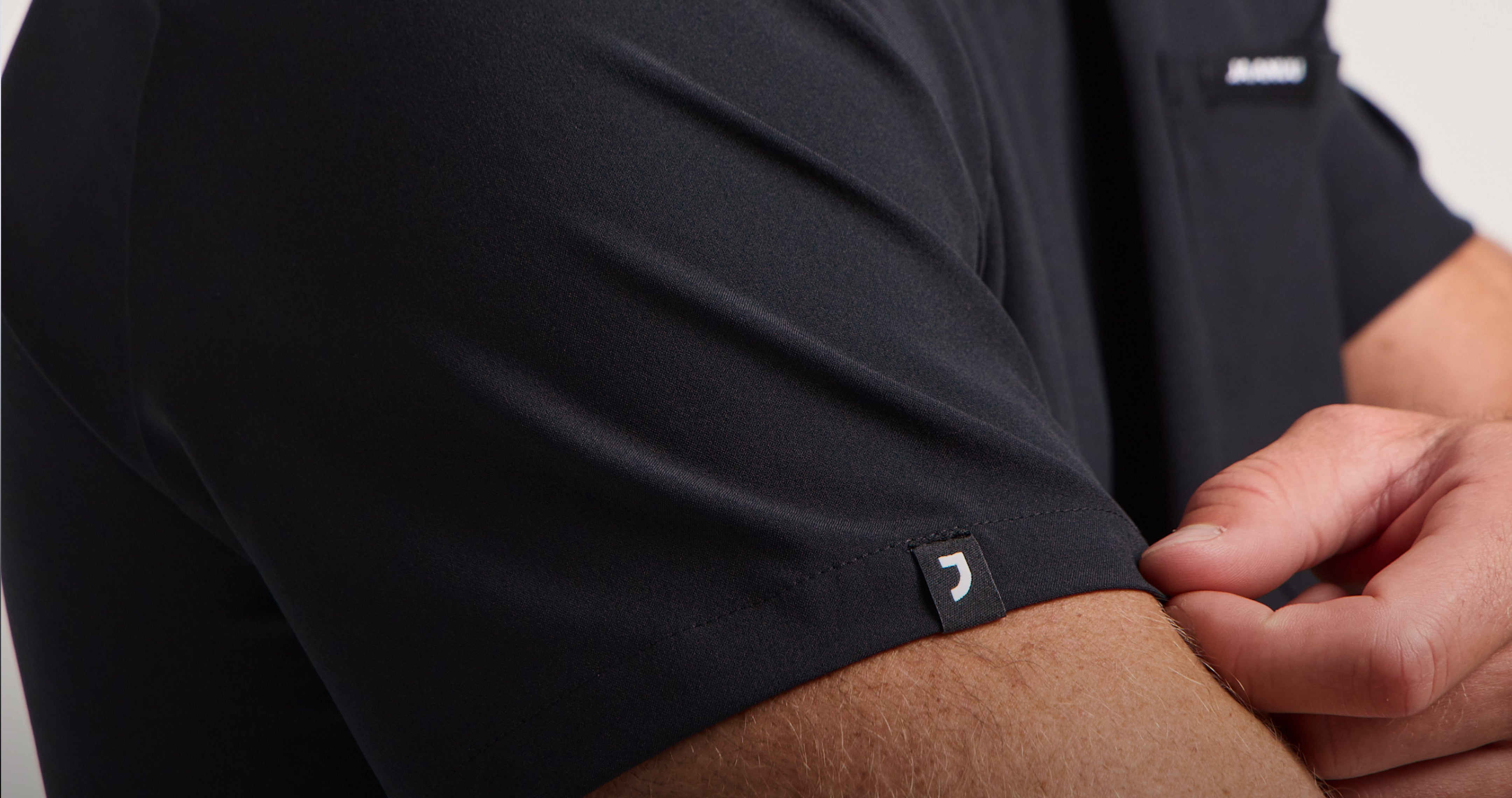 Close-up of a man's shoulder in a black UltraLITE™ scrub top