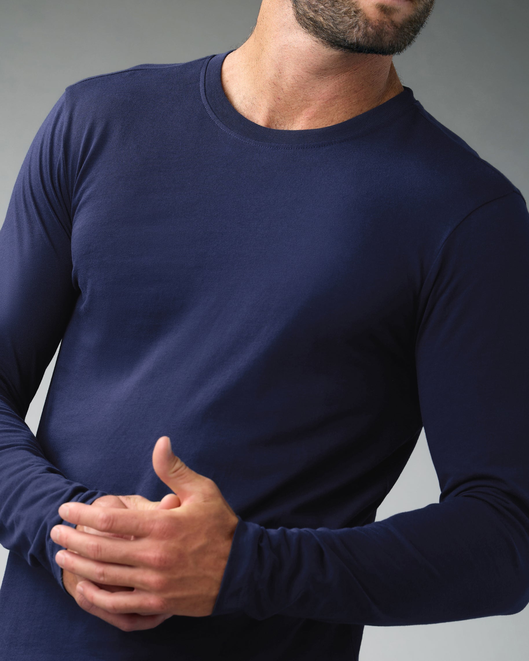 Man in a navy long-sleeve crewneck underscrub